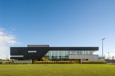 a large building sitting on top of a lush green field