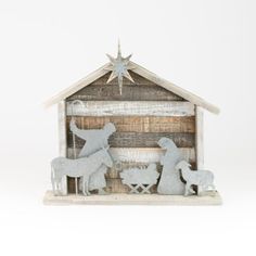 a wooden nativity scene with two sheep and a mangerm in the stable