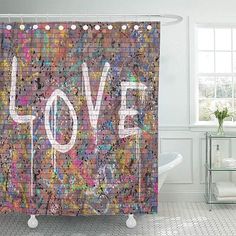 a shower curtain with the word love painted on it in multicolored squares and dots