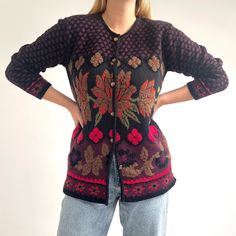 Beautiful, bold 80's cardigan in dark floral design with dark brass buttons. It has an elongated straight shape with a crew style neckline and is of a tight, airy knit with some chenille yarn, too. Fluffy, super soft and lightweight, it is perfect over jeans and plain dresses. Made in Italy by Show Room di Cecilia. 60% acrylic, 40% merino wool. Medium size. Measurements when laid flat are: Pit to pit: 54cm Waist: 53cm Length: 76cm Excellent condition. Vintage Floral Print Winter Cardigan, Vintage Floral Print Cardigan For Winter, Vintage Long Sleeve Sweater With Floral Print, Vintage Floral Print Winter Tops, Vintage Floral Print Cardigan For Fall, Vintage Winter Floral Print Tops, Vintage Winter Floral Cardigan, Fall Vintage Floral Print Cardigan, Vintage Black Sweater For Fall