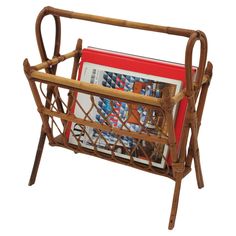 a magazine rack made out of bamboo with magazines in it's holder, on a white background