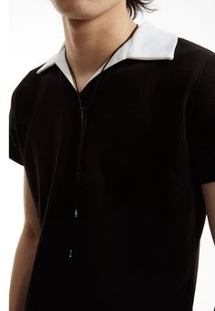 Experience a fresh take on a classic with our Slim Contrast Collar Zippered Polo Shirt, a sophisticated twist on everyday style. 

Crafted with attention to detail, this polo shirt features a sharp contrast collar and a contemporary zippered placket. The soft blend of premium cotton and nylon ensures both comfort and durability, while the juxtaposition of black and white adds a dynamic visual appeal. Its loose fit allows for easy movement and an on-trend, nonchalant vibe that transitions smoothl Modern Tops With Johnny Collar For Workwear, Casual Johnny Collar Tops For Work, Classic Johnny Collar Tops For Everyday, Black Collared Top For Casual Gatherings, Casual Polo Collar Tops For Work, Casual Tops With Polo Collar For Work, Modern Polo Collar Tops For Workwear, Modern Workwear Tops With Polo Collar, Classic Collared Tops For Casual Gatherings