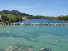 a large body of water with rocks in it