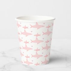 a paper cup with pink sharks on it