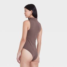 Refresh your separates closet as the seasons change with the Mock Turtleneck Tank Bodysuit from A New Day™. This sleeveless pull-on tank bodysuit is designed in elegant solid hues for a sophisticated look, and it features a mock turtleneck neckline for additional flair. The bodysuit is made from a soft and stretchy cotton-blend fabric to give you a comfortable fit that moves with you, and it boasts a full-coverage bottom with metal snaps at the crotch for added convenience and confident wear. We Solid Color High Neck Summer Bodysuit, Solid High Neck Summer Bodysuit, Solid High Neck Bodysuit For Summer, Solid High-neck Bodysuit For Summer, Casual High Neck Summer Bodysuit, Casual High Neck Bodysuit For Summer, Solid Color Sleeveless Second-skin Bodysuit, Solid Sleeveless Second-skin Bodysuit, Trendy Solid Color Sleeveless Bodysuit