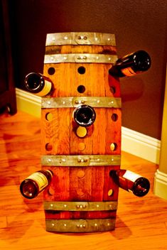 a wooden wine barrel sitting on top of a hard wood floor