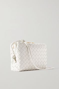 Bottega Veneta's 'Loop' shoulder bag has been hand-woven in Italy from strips of supple leather using the house's iconic intrecciato technique. It's sized to fit the essentials and has slim straps detailed with signature knots. White Rectangular Bag With Intrecciato Weave, Luxury White Woven Leather Shoulder Bag, Luxury White Shoulder Bag With Intrecciato Weave, Designer White Shoulder Bag With Woven Leather, White Woven Leather Evening Shoulder Bag, Luxury White Intrecciato Weave Shoulder Bag, White Shoulder Bag With Intrecciato Weave For Travel, Elegant White Shoulder Bag With Intrecciato Weave, White Intrecciato Weave Crossbody Bag