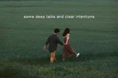 two people are walking in the grass with one holding the other's hand and saying some deep talks and clear intentionss