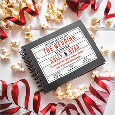 a movie themed wedding book surrounded by red streamers