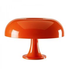 an orange table lamp on a white background