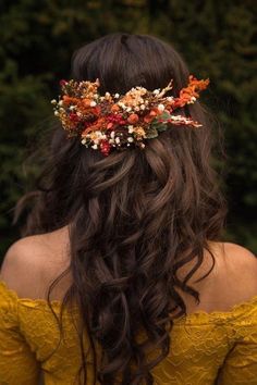 a woman with long hair wearing a flower crown