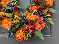 Bursting with fall hues, this vibrant oval wreath combines pumpkins, rich hydrangeas and peonies, and plump berries to create a dynamic, full-bodied look. The reds, oranges, and deep greens give a warm, welcoming feel to any space, whether indoors or covered outdoors. Perfect for those looking for a bold statement piece to celebrate the richness of the autumn season. (Psst...Have an extra tall door? Or narrow entryway? This wreath is a perfect fit for unique spaces.) Faux Peonies, Table Wreath, Oval Wreath, Wreath Hangers, Narrow Entryway, Blue Berries, Grape Harvesting, Harvest Wreath, Harvest Thanksgiving