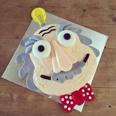 a cake decorated with an evil face and bow tie