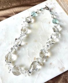 Quartz crystal is a clear natural stone with inclusions and variations in shape. Each stone has a unique shape. A few faceted aqua stones near the clasp add a fun hint of color. This 18inch necklace has a large sterling silver toggle that is easy to clasp. It gorgeous with an evening gown on a special occasion, but also fun enough to add class to a more casual outfit. Aqua Stone, Clear Quartz Crystal, Bead Jewellery, Crystal Quartz, Quartz Necklace, Fort Worth, Clear Crystal, Evening Gown, Casual Outfit