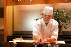 a chef is making sushi rolls in the kitchen