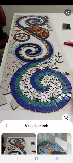 an image of a mosaic tile design being worked on by someone who is using the app