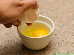 an egg being boiled in a small white cup