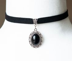 This Victorian inspired choker is made from black faux suede, embellished with an antique silver filigree pendant/cameo with a black agate stone. - The choker measures 11.5 inches in length (without the lobster claw and 12 inches with the claw) and 3/4 inch in width - The pendant is approximately 1.25 inch long and 1 inch wide - The choker closes with a lobster claw clasp at the back - One size fits most (for a neck of about 12.5 inches). there is a 2 inch extension chain at the back to accommod Elegant Black Formal Choker, Classic Black Choker Jewelry, Elegant Onyx Choker Jewelry, Cameo Choker Necklace, Cameo Choker, Gothic Choker, Black Agate Stone, Gothic Chokers, Vintage Inspired Jewelry