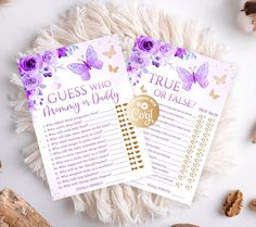 two purple and gold wedding guess game cards on a white rug next to some nuts