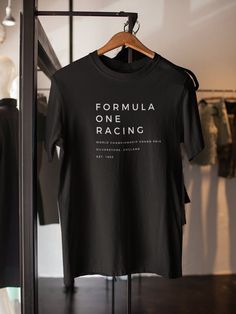 The FORMULA RACING graphic tee will be your new go to uniform for race day! It is ultra comfortable, lightweight! #2023 #SundayRaceDay #GiftForHim #GiftForHer #DrivingFan #VintageTShirt #Menstyle #Summer #WhiteShirt #PrintTShirt #MensGraphicTShirt #Athletic #PrintTShirt This t-shirt is everything you've dreamed of and more. It feels soft and lightweight, with the right amount of stretch. It's comfortable and flattering for all.  * 100% combed and ring-spun cotton (Heather colors contain polyeste Sporty Branding T-shirt For Team Events, Sporty Team Events T-shirt With Branding, Sporty Branded T-shirt For Team Events, Sporty Tops With Letter Print For Motorsport Events, Branded Short Sleeve T-shirt For Team Events, Branded Crew Neck Tops For Team Events, Racing Style Tops For Motorsport Events, Black Graphic Print Tops For Motorsport Events, Cotton T-shirt With Branding For Team Events