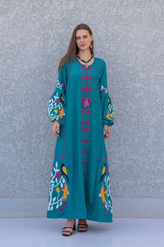 "A stunning embroidered Kaftan dress that is elegant, colorful, and unique! The dress is made of Egyptian cotton that has a soft feel to it so you will surely feel comfortable and royal in it. It also comes with a small invisible pocket on the right side of the Kaftan for added practicality.  You can wear this Kaftan practically anywhere and for any occasion. You can dress it up with a pair of heels and strut like an Egyptian queen in any gathering, resort, or party. Or you can dress it down wit Green Floral Embroidered Maxi Dress, Floral Embroidered Floor-length Kaftan For Eid, Green Embroidered Floor-length Maxi Dress, Embroidered Green Floor-length Maxi Dress, Floral Embroidered Floor-length Maxi Dress For Eid, Traditional Floor-length Maxi Dress With Floral Embroidery, Spring Maxi Length Abaya, Floor-length Maxi Dress With Floral Embroidery For Eid, Floor-length Floral Embroidered Maxi Dress For Eid