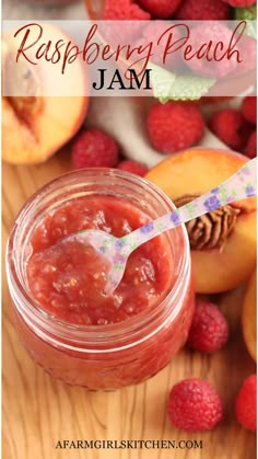 raspberry peach jam in a jar with a spoon