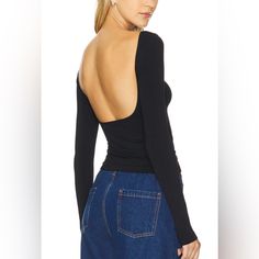 A Sleek Long-Sleeve Top Featuring A Slim Fit And A Stylish Boat Neck, Highlighted By A Low Scoop Back For A Distinctive Look. - Boat Neck - Low Scoop Back - Long Sleeves - 92% Nylon, 8% Spandex - Machine Wash, Dry Flat - Imported Trendy Backless Tops For Fall, Versatile Stretch Backless Tops, Versatile Fitted Backless Top, Backless Fitted Top For Night Out, Casual Seamless Backless Top, Versatile Backless Top For Night Out, Black Spring Top With Thumbholes, Black Spring Tops With Thumbholes, Versatile Black Tops With Thumbholes