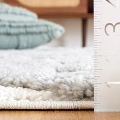 a close up of a bed with a growth chart next to it