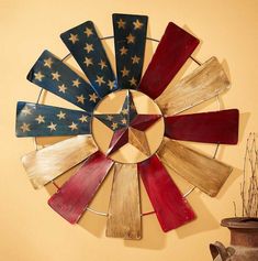 an american flag painted on the side of a metal wall decoration with red, white and blue strips