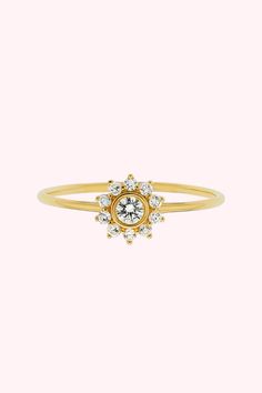 This 14kt gold diamond sunflower ring is a sparkly, feminine way to wear diamonds by incorporating your favorite floral. This stackable engagement ring pairs well with many of our dainty diamonds arcs.

This dainty sunflower ring stacks with the 14kt Solid Gold Diamond Arc Ring to complete the look! We also offer this stunning sunflower ring with a teal-colored sapphire center. Yellow Gold Diamond Stackable Rings With Center Stone, Dainty Flower-shaped Diamond Ring, Dainty Cluster Ring With Center Stone, Dainty 14k Gold Cluster Ring With Halo Setting, Dainty Diamond Flower Ring In White Gold, Dainty Yellow Gold Diamond Cluster Ring, Dainty Yellow Gold Halo Diamond Ring, Dainty Diamond Ring With Halo, Dainty Diamond Ring With Halo Setting