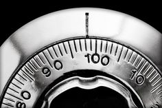 a close up of a combination lock on a black and white background with focus on the dial