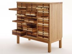 a wooden cabinet filled with lots of different types of drawers on top of each other