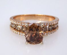 an engagement ring set with a fancy brown diamond and two rows of diamonds on each band