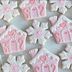 pink and white decorated cookies on a table