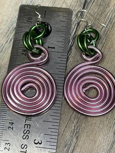 Nothing like these simple Round Pink Circles accented with green, inspired by the sorority AKA to have for days you throw on a pair of jeans or you dress up with a suit. You can't go wrong with them! Aluminum wire jewelry made by me with Love! I create fun handcrafted jewelry from anodized aluminum and sterling silver. Items are ready to ship, made to order and can be custom made to order. * Handmade Please note the picture is zoomed close to show the detail of the item *Items are handcrafted wh Green Earrings For Everyday, Handmade Adjustable Green Wrap Earrings, Adjustable Handmade Green Wrap Earrings, Casual Green Dangle Jewelry, Casual Green Nickel-free Jewelry, Green Dangle Wrap Earrings With Ear Wire, Green Drop Wrap Earrings With Ear Wire, Green Wrap Drop Earrings With Ear Wire, Casual Green Drop Earrings