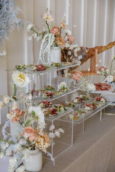 a table with flowers and plates on it