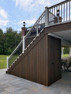 an outdoor patio with stairs and tables