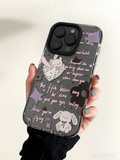 a person holding up a phone case with an image of a bunny and rabbit on it