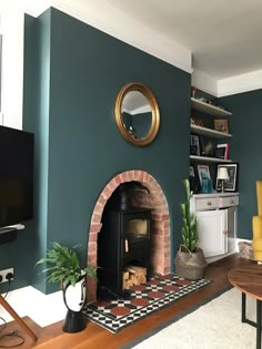 a living room filled with furniture and a fire place next to a wall mounted tv