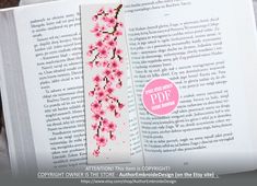 a cross stitch bookmark with pink flowers on it and the words,'congratulations this is