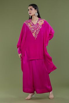 Rani pink high low kaftan with french knots, thread embroidery in floral pattern on neckline. Paired with pant. - Aza Fashions Traditional Pink Kaftan With Traditional Drape, Pink Silk Embellished Sets, Embellished Pink Silk Sets, Pink Embellished Silk Sets, Pink Chikankari Embroidery Kaftan For Spring, Spring Pink Kaftan With Chikankari Embroidery, Traditional Pink Maxi Length Palazzo Set, Traditional Pink Kaftan With Resham Embroidery, Pink Floor-length Kaftan For Festive Occasions