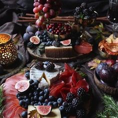 an assortment of fruits and cheeses on plates