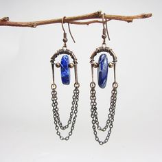 Long hammered copper earrings with Lapis Lazuli. Total length including ear wires is approx 3.15 x 0.6inches or 80 x 15mm.  Personally, I manually produce all of my jewelry in my home studio. The package will be sent by registered mail. All my products are safely and nicely packed in solid gift boxes ready for donation. Enter my shop here:  https://www.etsy.com/shop/DrahomiraJewelry Bohemian Lapis Lazuli Earrings, Handmade Blue Brass Chandelier Earrings, Handmade Lapis Lazuli Bohemian Earrings, Blue Bohemian Hand Forged Earrings, Blue Hand Forged Bohemian Earrings, Hand Forged Blue Metal Jewelry, Wire Earring Ideas, Hammered Copper Earrings, Wire Earring