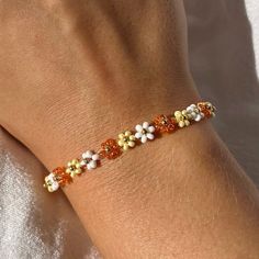 FREE SHIPPING within Germany. The bracelet consists of glass beads in white, yellow and orange and a 14k gold-plated clasp. A piece of jewelry for every occasion. Each bracelet is made individually for you and has an additional extension chain of approx. 2.5 cm. Size Before ordering, measure the size of your wrist to ensure a precise fit materials * Glass beads * Nylon thread * 14k gold plated stainless steel If you have any questions, feel free to write me a message :) Orange And Silver, Jaune Orange, Fruit Pattern, Flower Bracelet, Bead Designs, Beaded Flowers, Yellow Orange, Flower Patterns, Favorite Jewelry