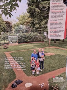 the family is posing for a photo on the baseball field