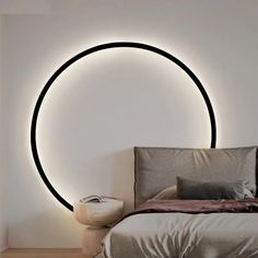 a bedroom with a circular light on the wall