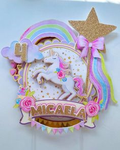 there is a cake with a unicorn on it and the name miara written in gold