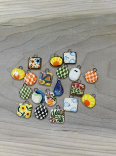 a collection of colorful glass pendants sitting on top of a wooden table