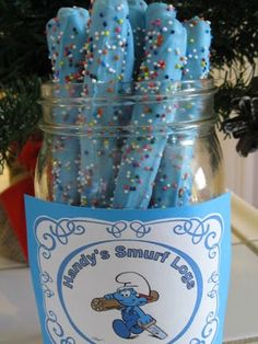 a jar filled with blue frosted donuts sitting on top of a counter