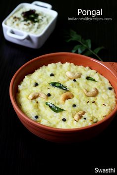 a bowl filled with rice and nuts on top of a table next to a container